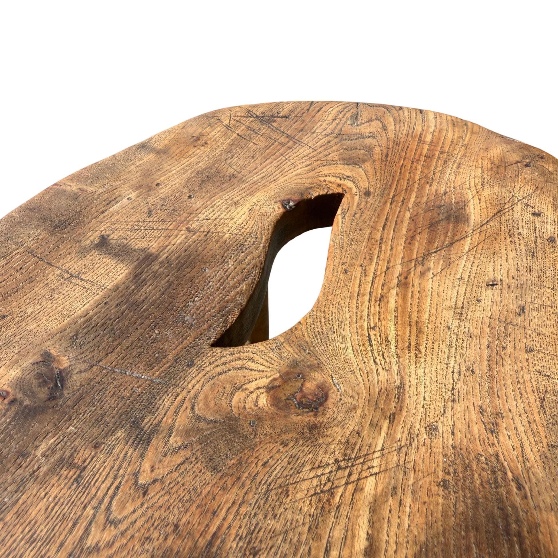 Angle view of solid wood stool highlighting patina and surface wear