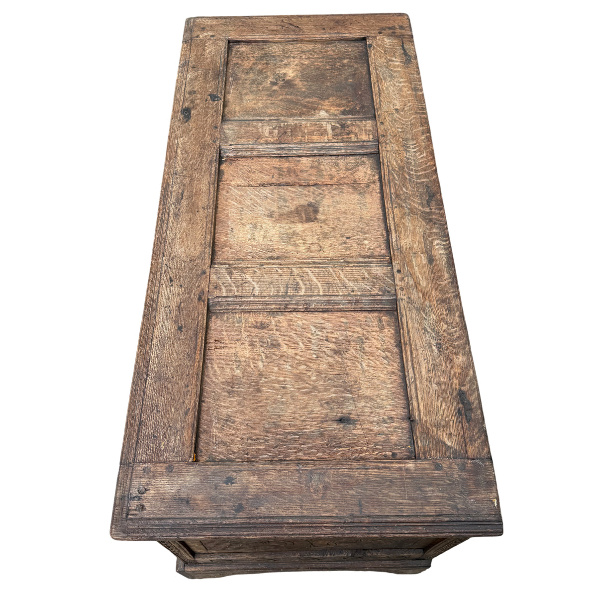 Carved oak chest corner showing carved leg and decorative panel