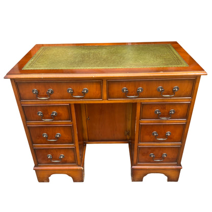 Vintage kneehole desk with inset green leather writing surface and wooden drawers