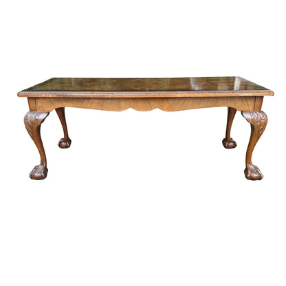 Corner view showing edge wear and small chips on walnut coffee table
