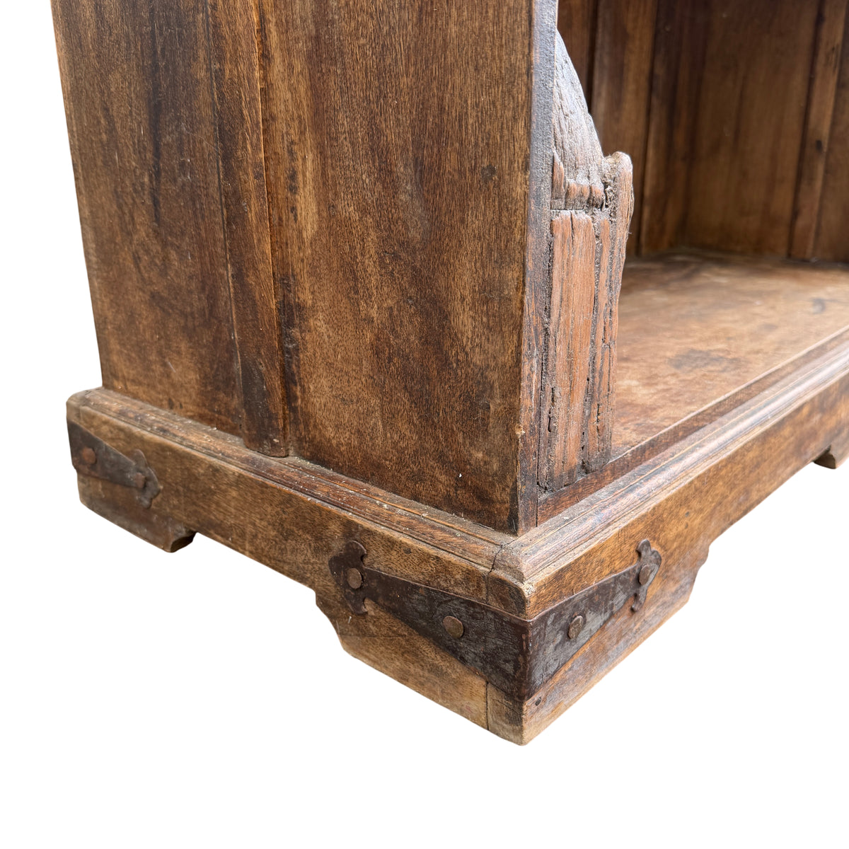 Full height view of tall rustic carved oak bookcase outdoors
