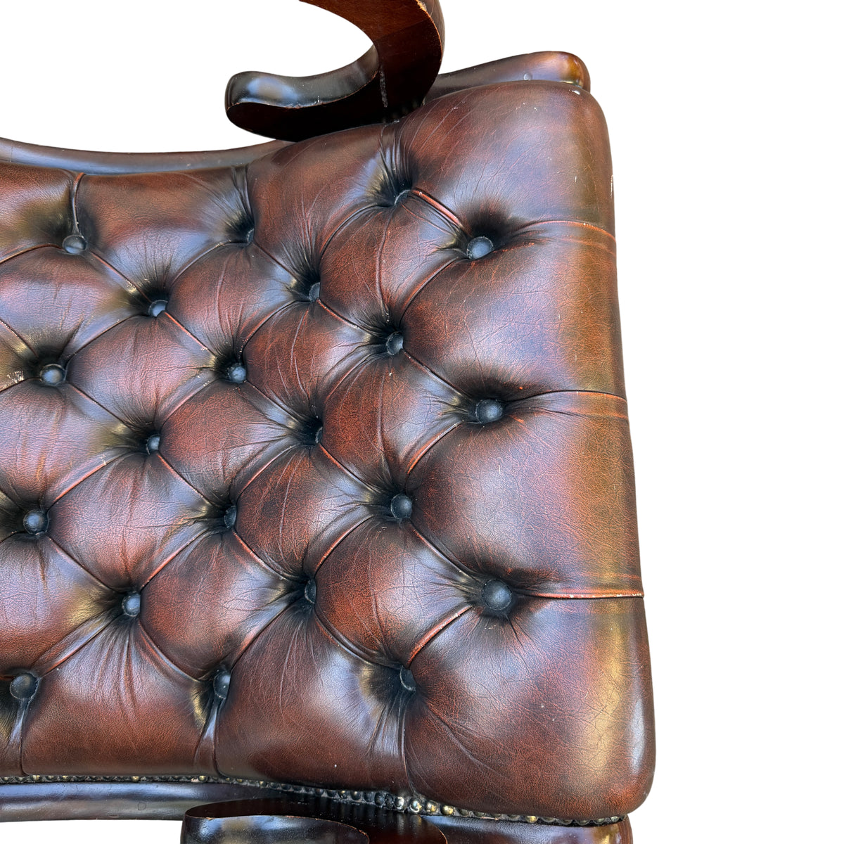Front view of tufted leather lounge chair with low seat profile