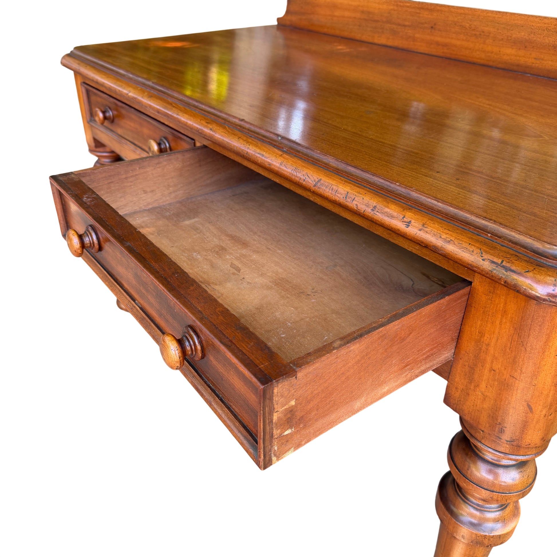 Side view of small Victorian console table with turned legs and casters