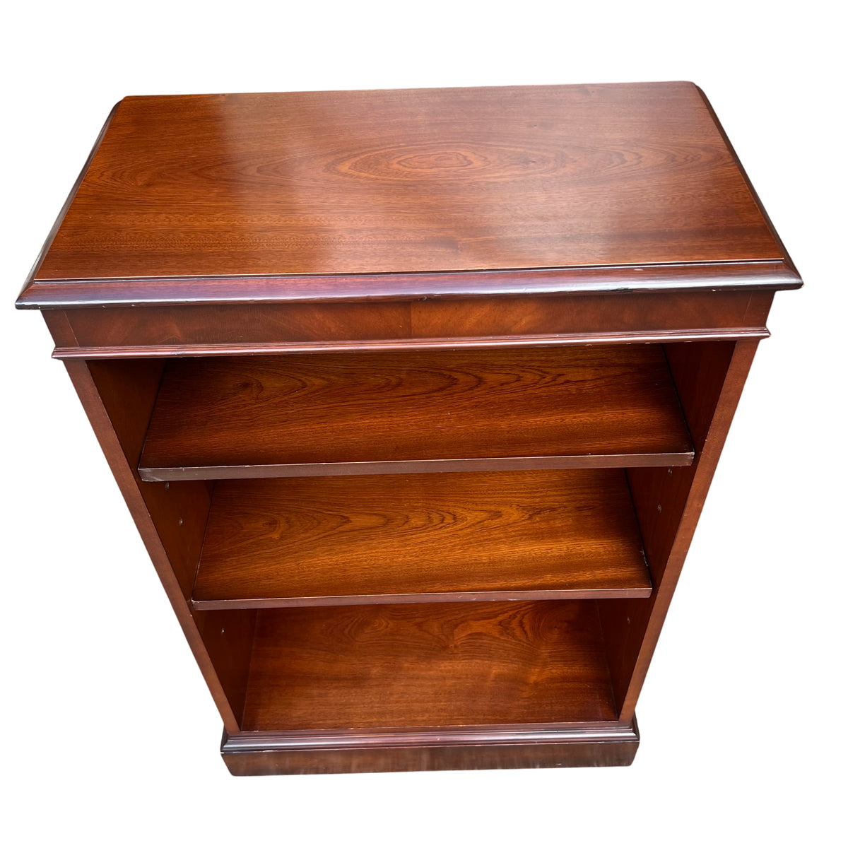 Close-up of adjustable shelf with shelf pin holes on mahogany bookcase
