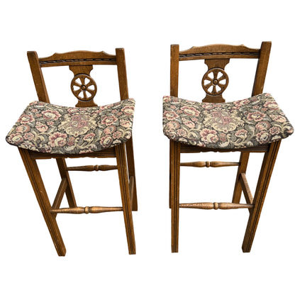 Side view of an Old Charm oak bar stool with patterned fabric seat and tall legs