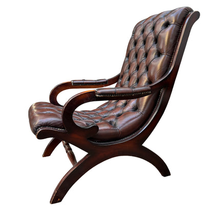 Side view of wooden frame and curved arm on button-tufted leather armchair
