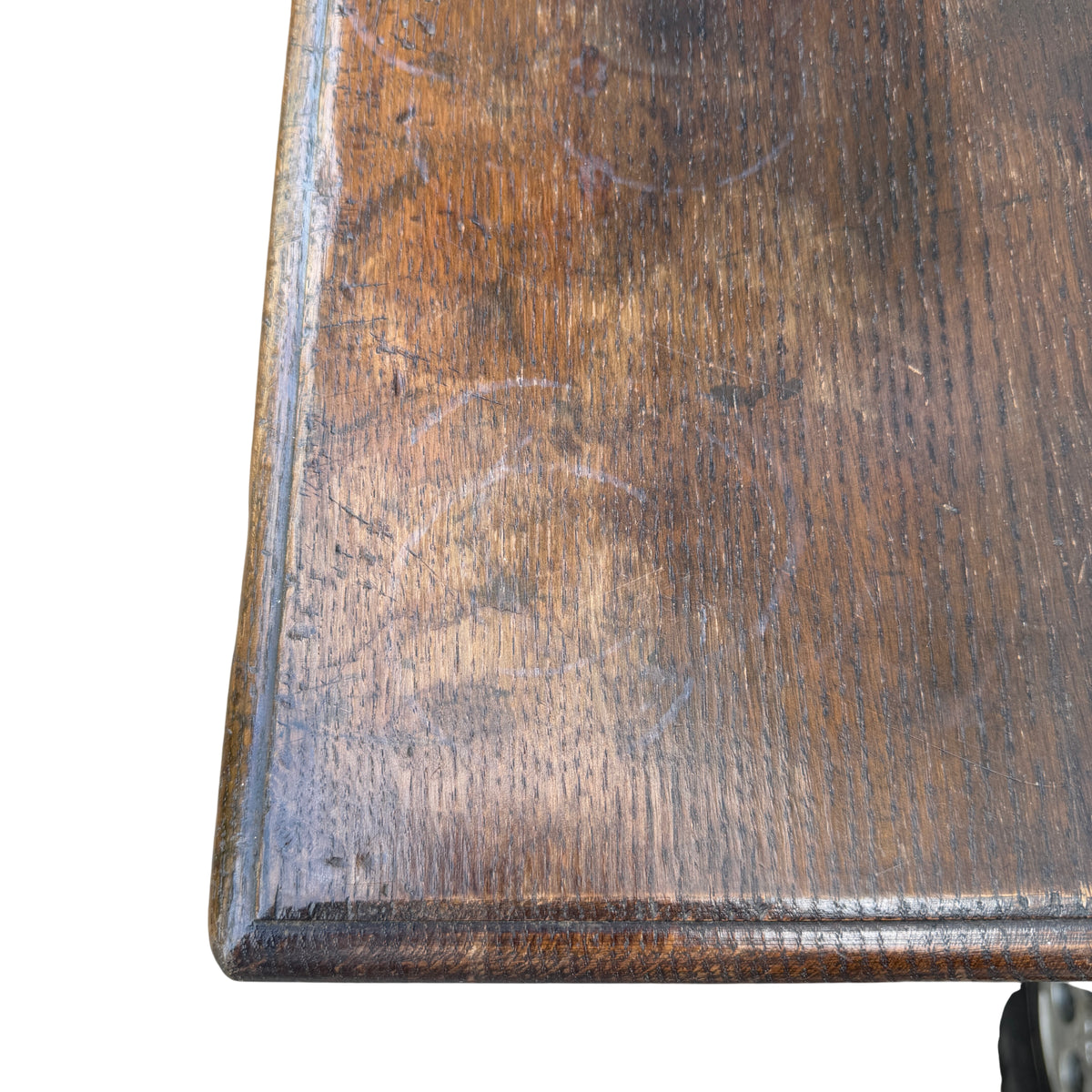 Close-up of oak cabinet doors with carved arched panels and key escutcheon