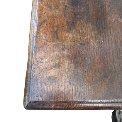 Close-up of oak cabinet doors with carved arched panels and key escutcheon
