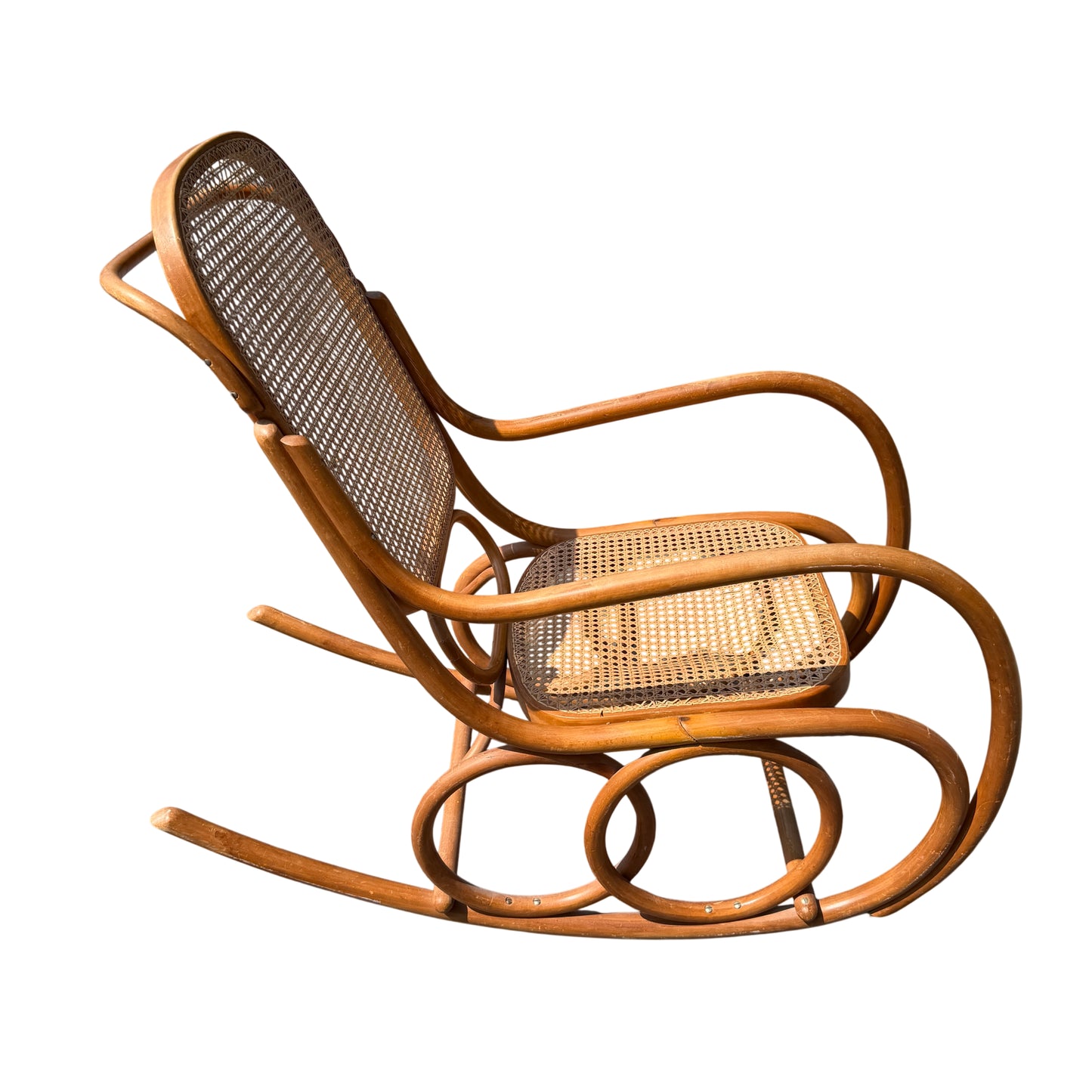 Detailed shot of cane weave pattern and timber edging on rocking chair seat