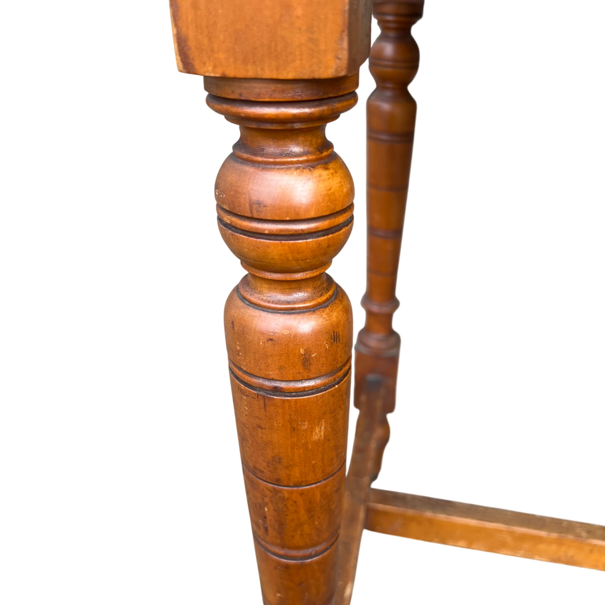 Close-up of turned leg with ring turned details and original caster