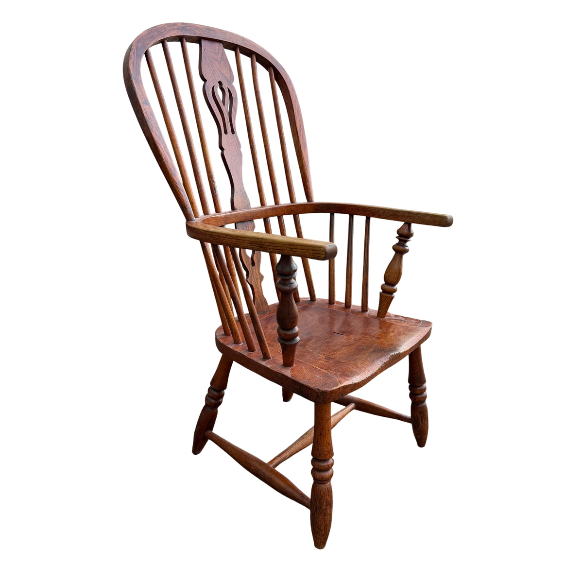 Side angle of Windsor-style oak armchair with turned arm supports and legs