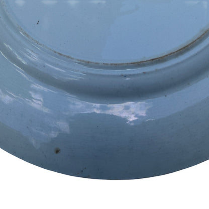 Detail of pagoda and boat scene on blue transferware porcelain plate