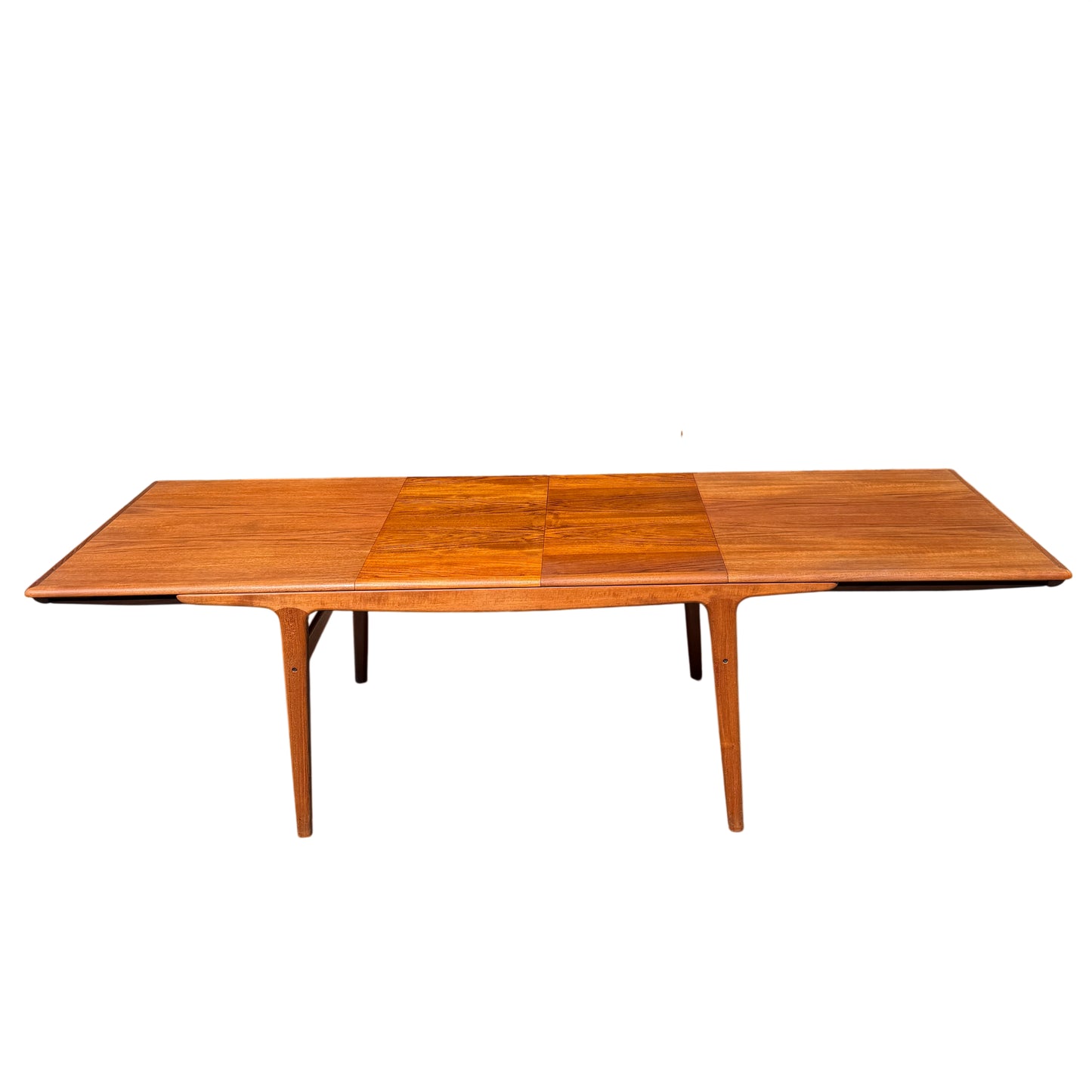 Rectangular teak dining table with mid century tapered legs ready for extension