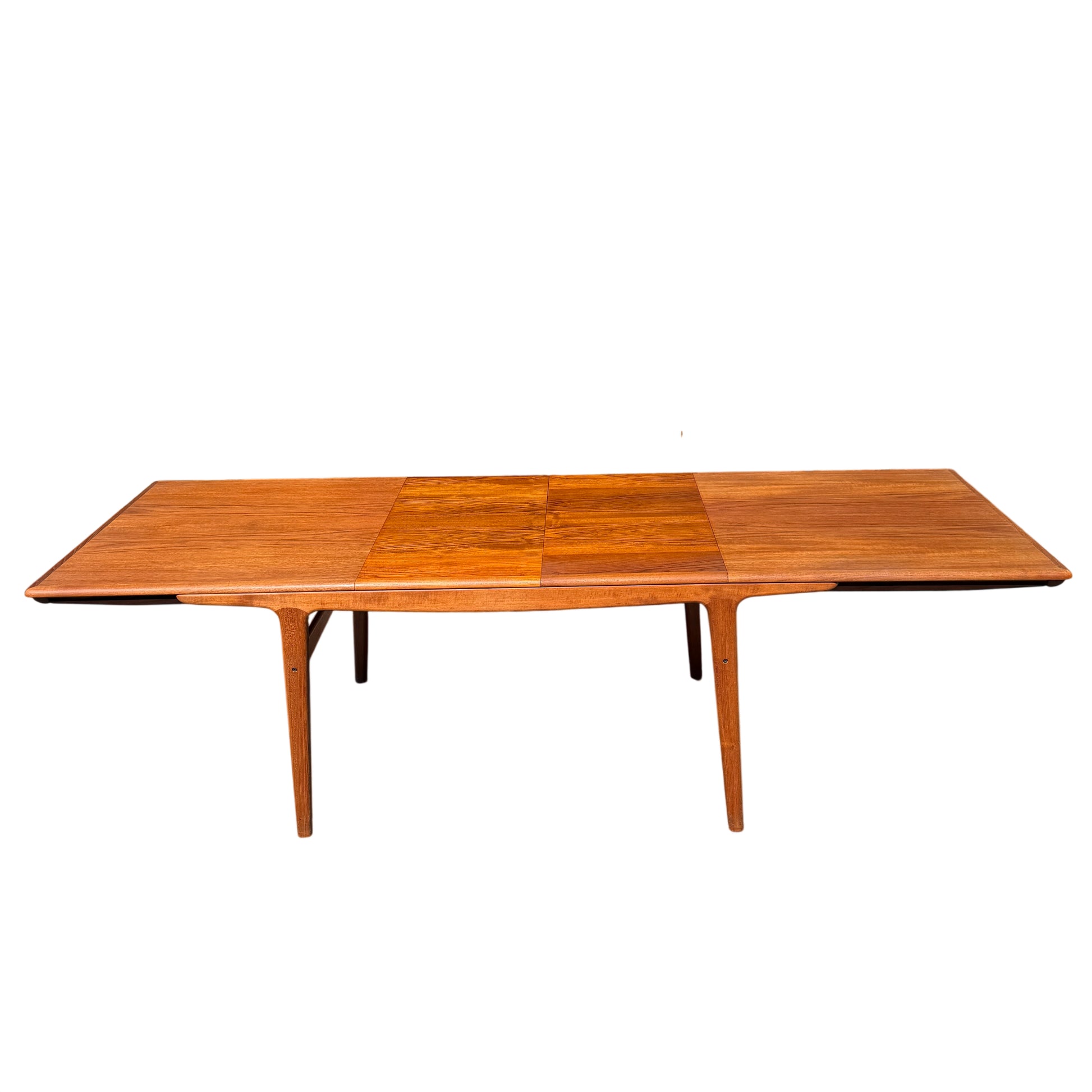 Rectangular teak dining table with mid century tapered legs ready for extension