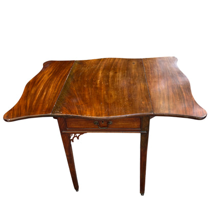 Side view showing drop leaf and slender tapered leg of occasional table