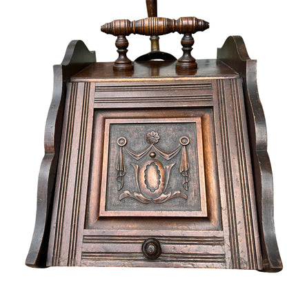 Victorian carved wooden coal scuttle with turned handle brass shovel and decorative carved front