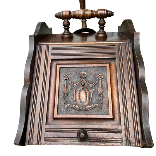 Victorian carved wooden coal scuttle with turned handle brass shovel and decorative carved front