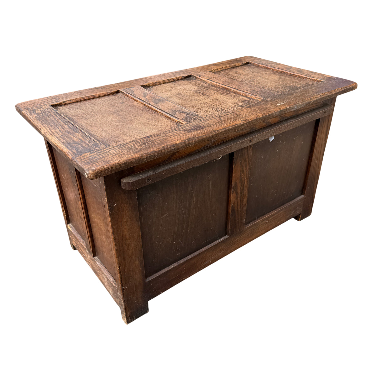 Worn oak finish and shallow scratches visible on the top surface of the chest