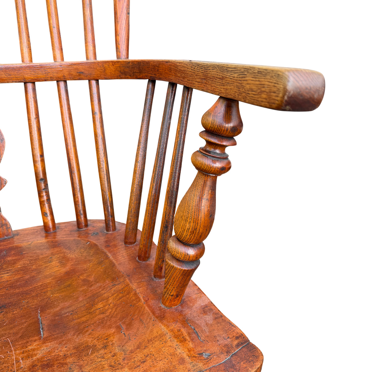 Underside area and seat edge of Windsor-style oak armchair with small chips