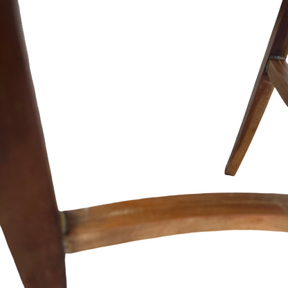 Compact round side table with four tapered legs and stretcher