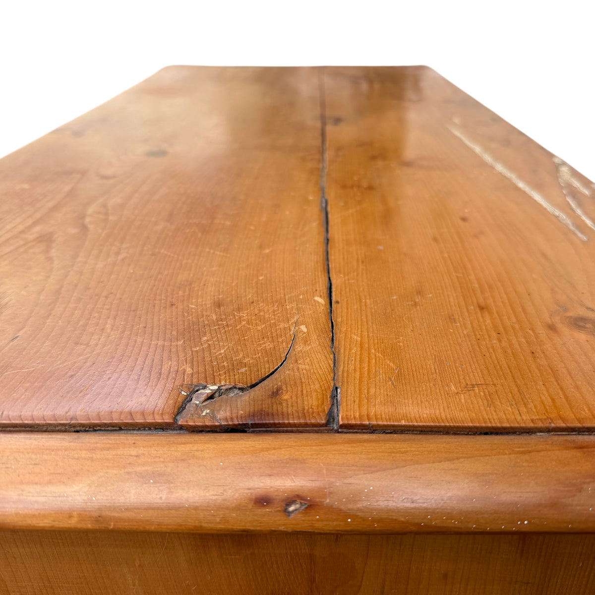 Top surface of pine chest showing natural knots and surface marks