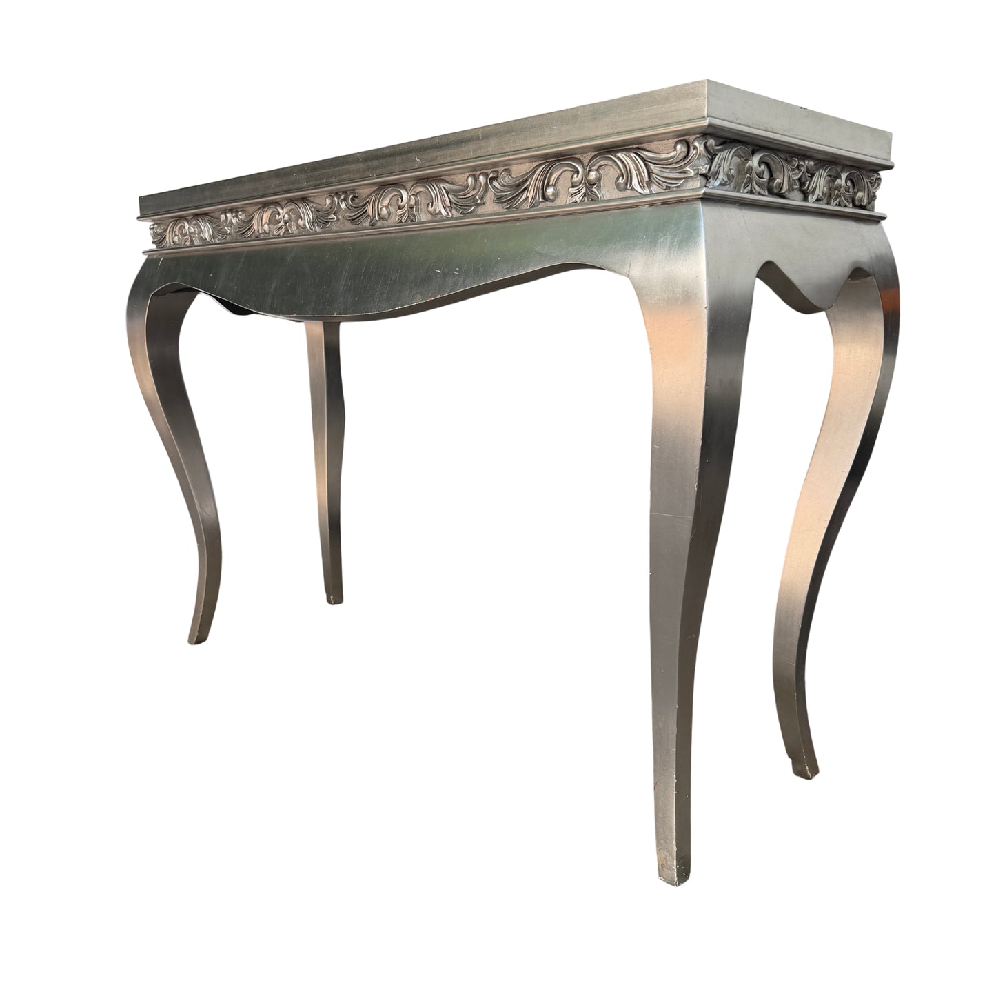 Side view of silver painted console table showing carved frieze and sweeping cabriole-style legs