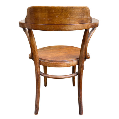 Close detail of finish wear and light scratches on a bentwood chair arm