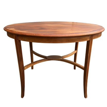 Vintage round wooden side table with slender legs and arched stretcher