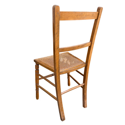 Vintage wooden dining chair set against outdoor background