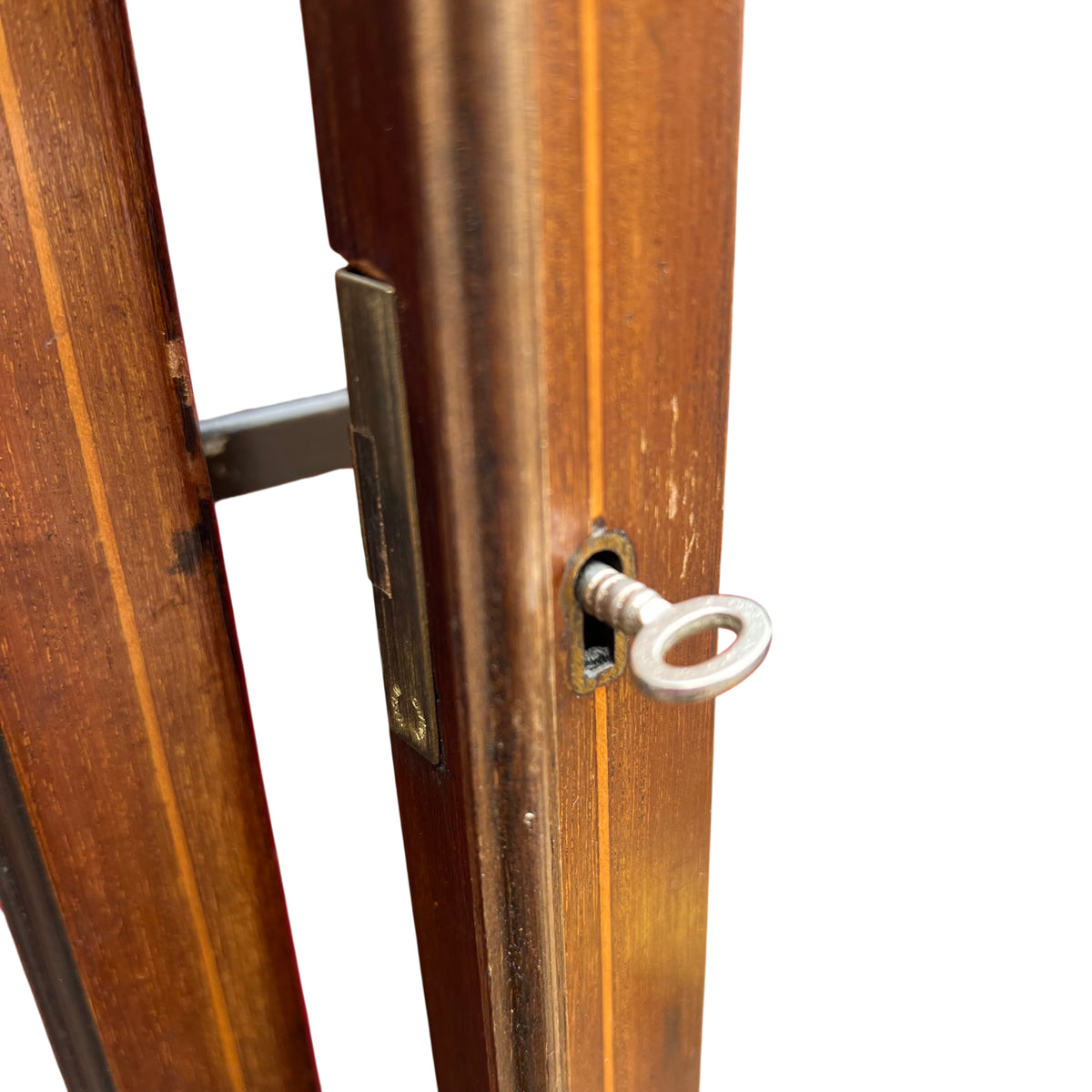 Red lined interior shelves inside a glazed mahogany display cabinet