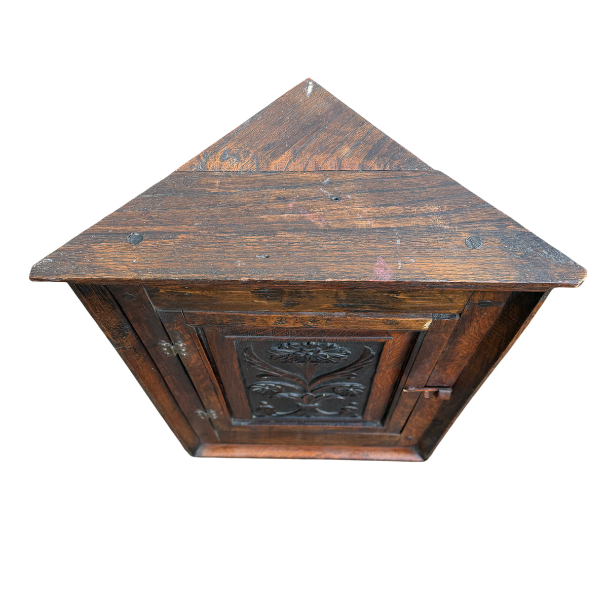 Full front view of small oak wall mounted corner cabinet with carved door