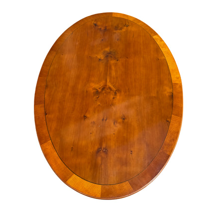 Pedestal dining table with turned central column and splayed legs on castors