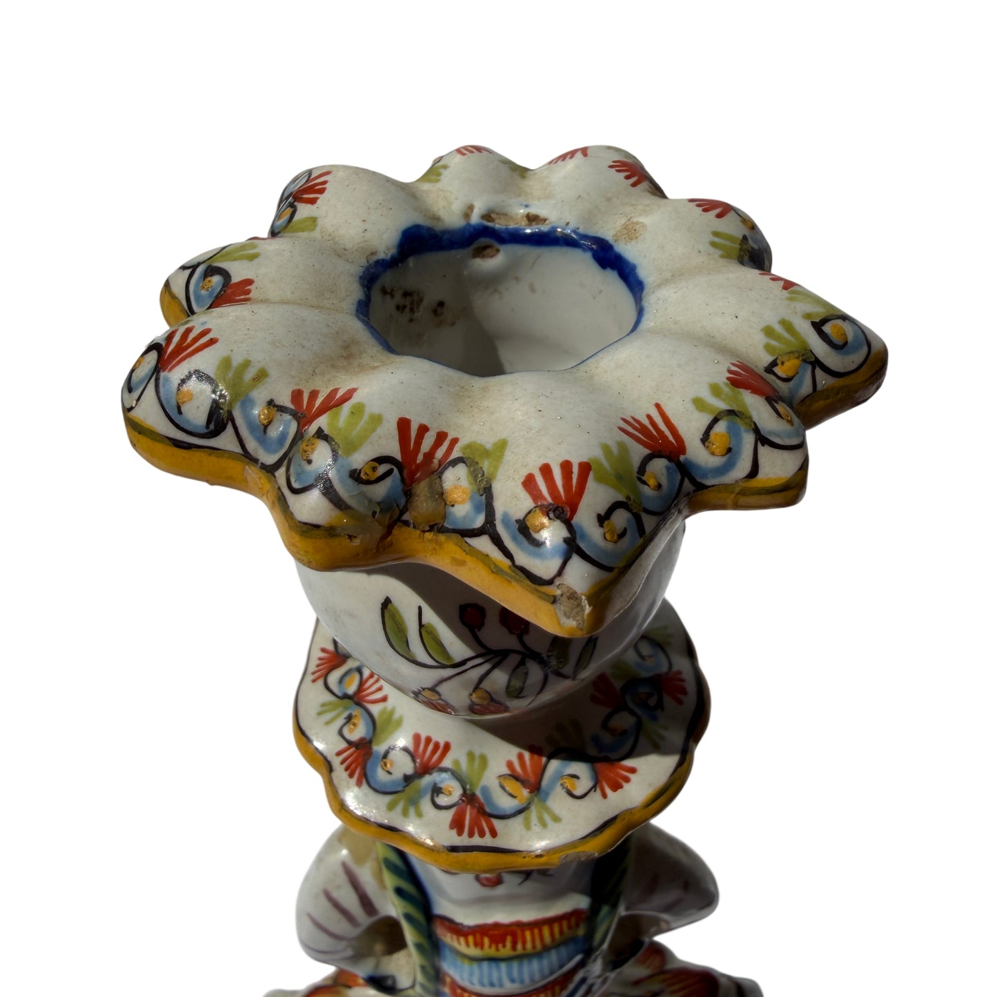 Lower section showing scrolling feet and mask motif on painted ceramic candlestick