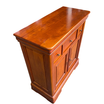 Full height view of compact wooden cupboard on moulded bracket feet