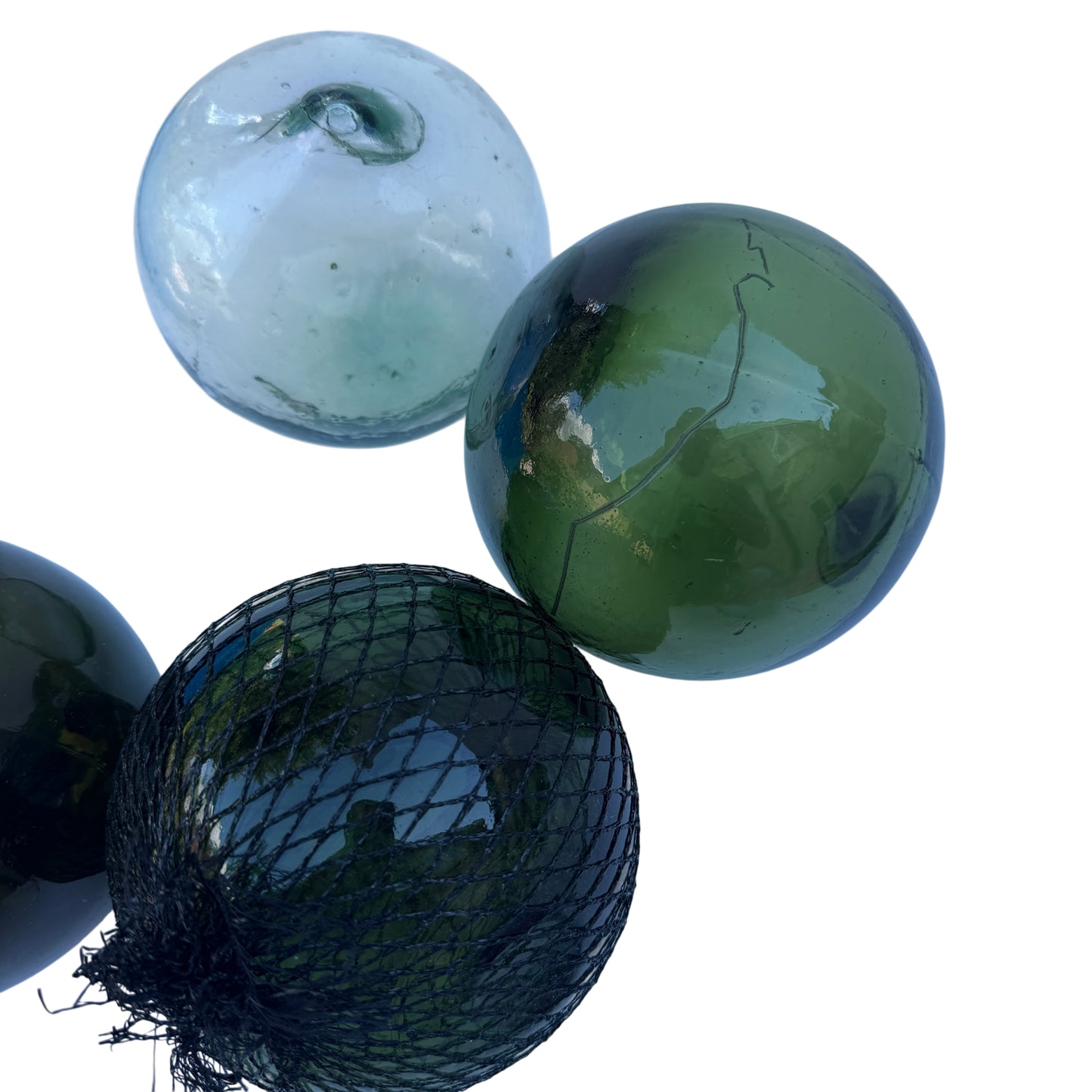 Dark olive glass float showing surface scratches and reflective glaze