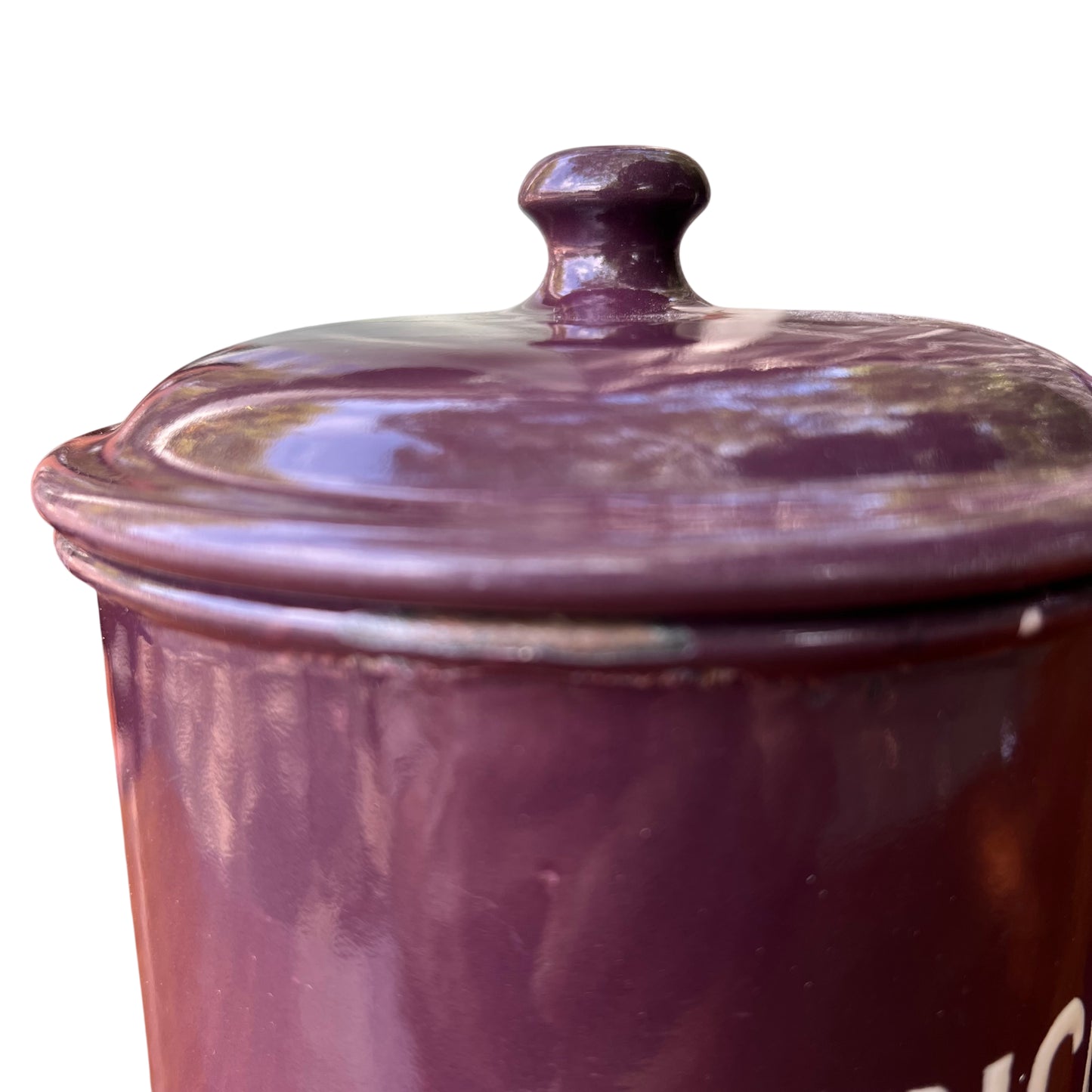 Two purple enamel canisters labelled Sultanas and Currants seen from above