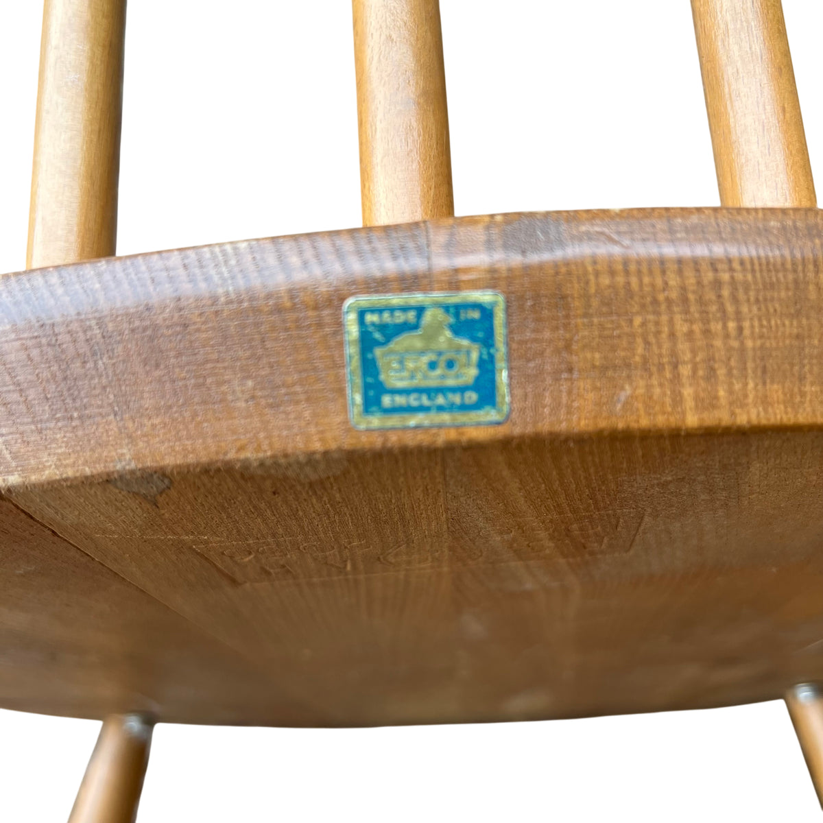 Side view of vintage wooden rocking chair arm and spindle back in light wood