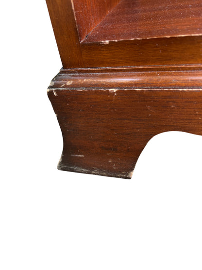 Close-up of brass bail handle on mahogany bedside drawer