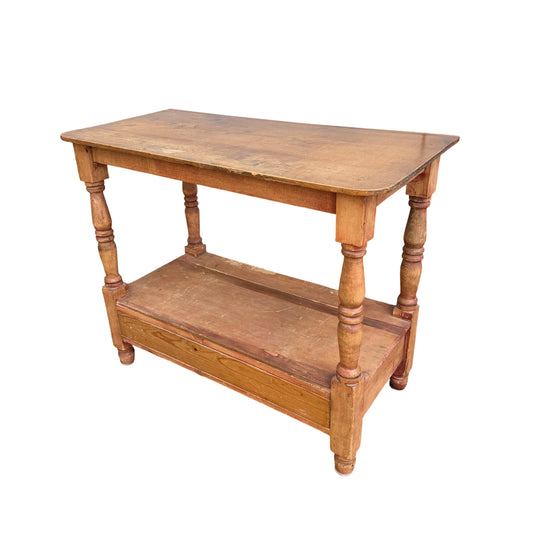 Vintage pine hall table with turned legs and lower storage shelf shown at an angle