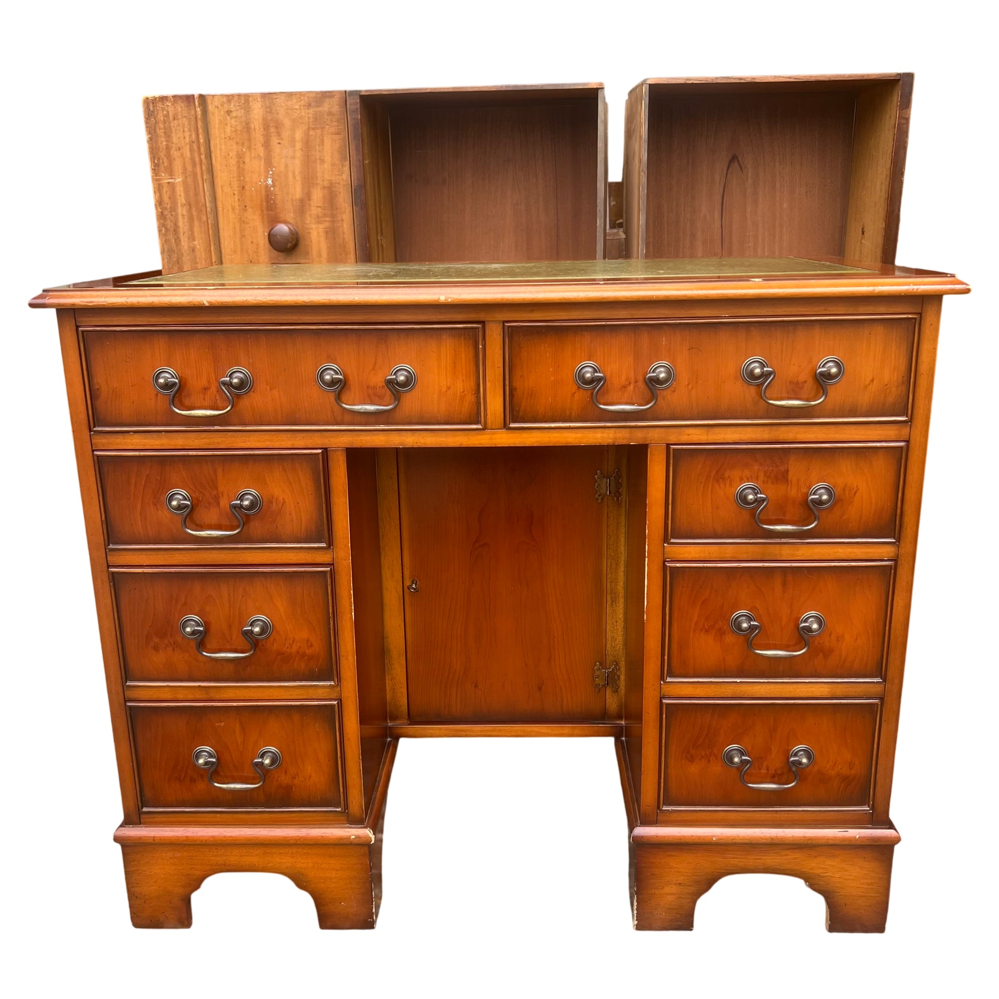 Front view vintage wooden kneehole desk with brass-effect drop handles