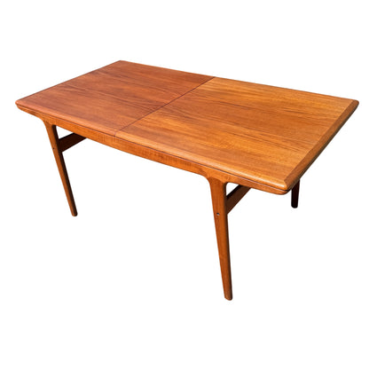 Teak extending dining table top with visible grain and central seam for drop-in leaves