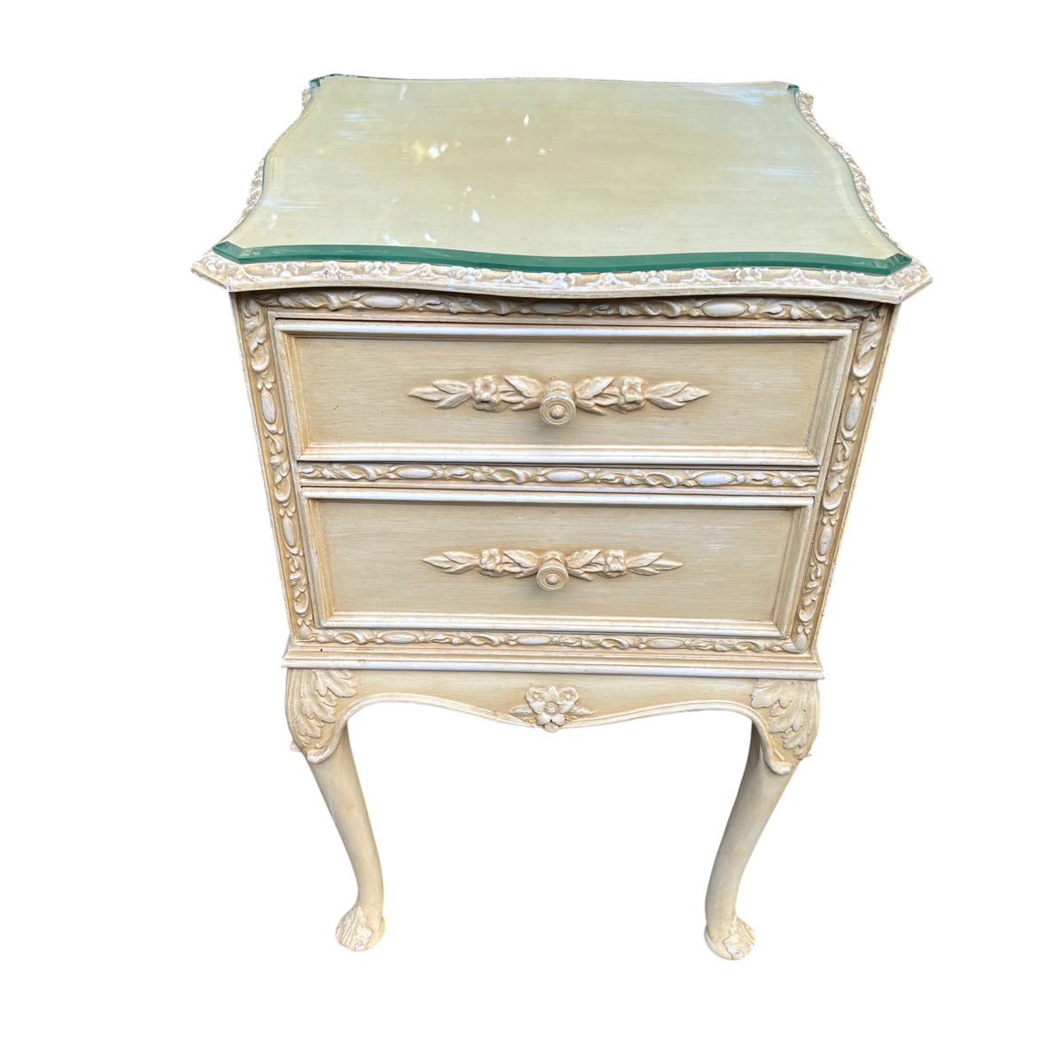 Side view of painted bedside cabinet showing carved vertical ornament and moulding