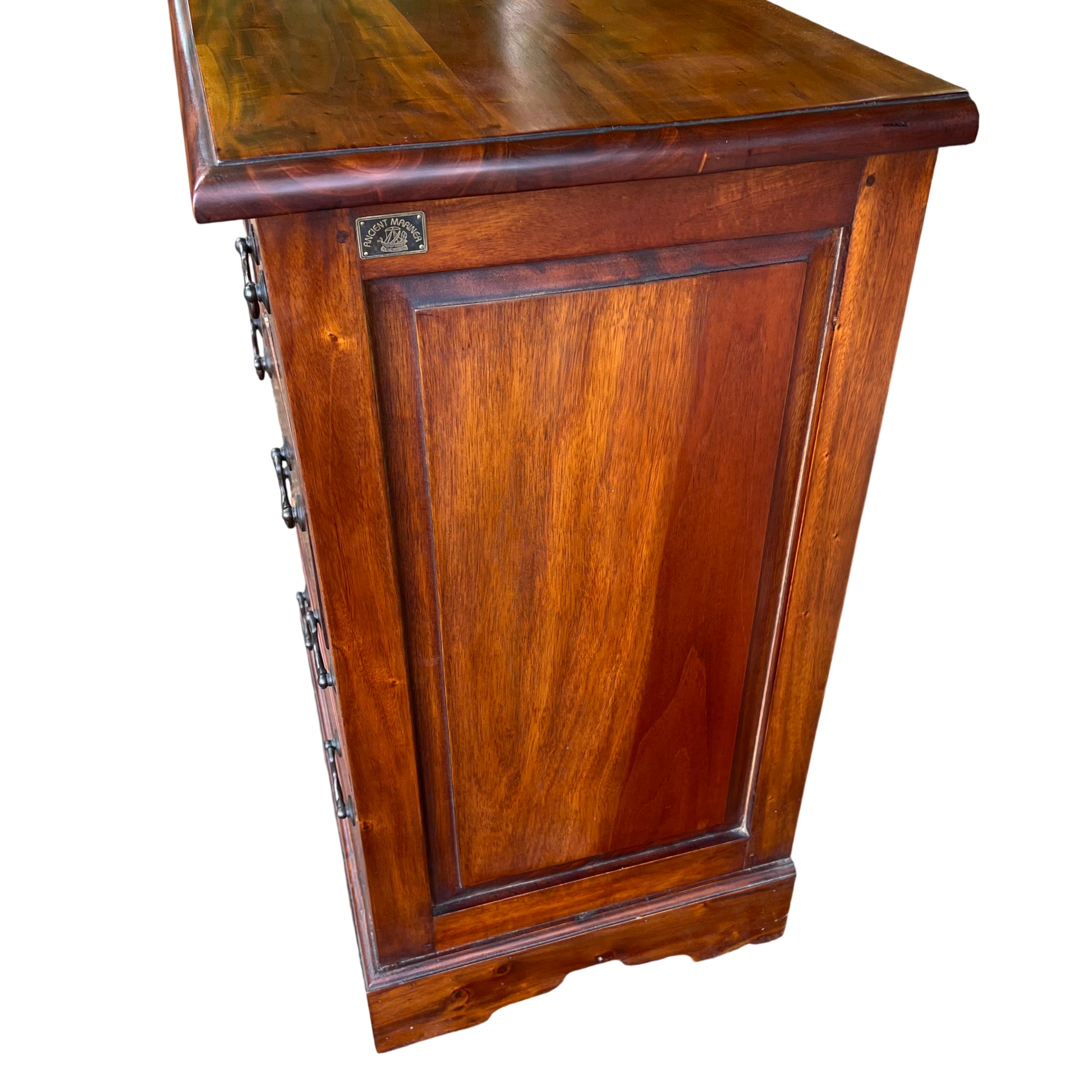 Pair of metal drop handles on the upper drawers of a narrow hardwood chest