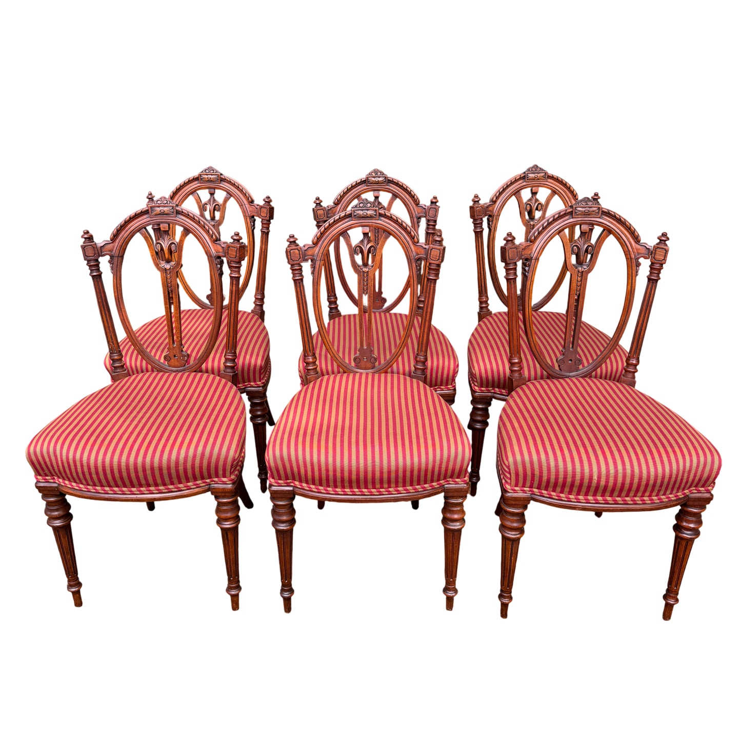 Three Victorian carved dining chair backs showing oval pierced carving and turned finials