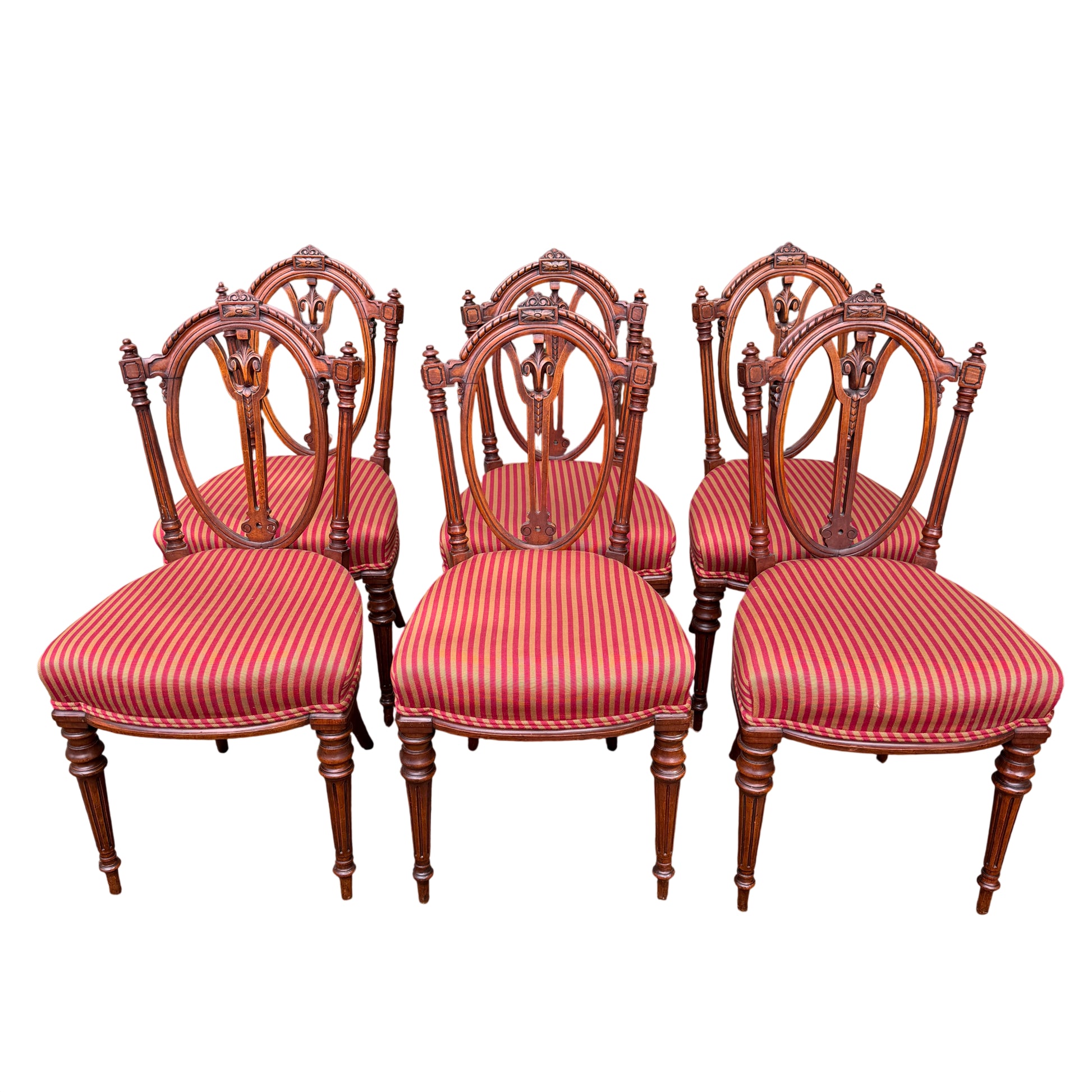 Three Victorian carved dining chair backs showing oval pierced carving and turned finials
