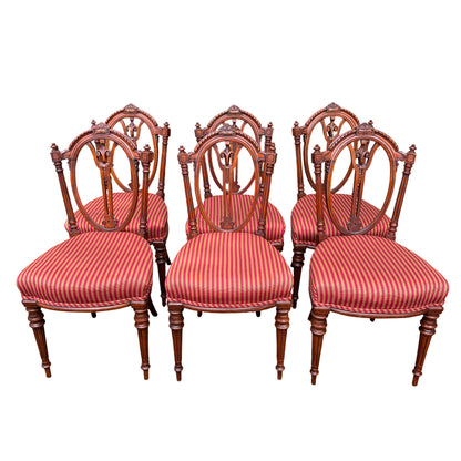 Three Victorian carved dining chair backs showing oval pierced carving and turned finials