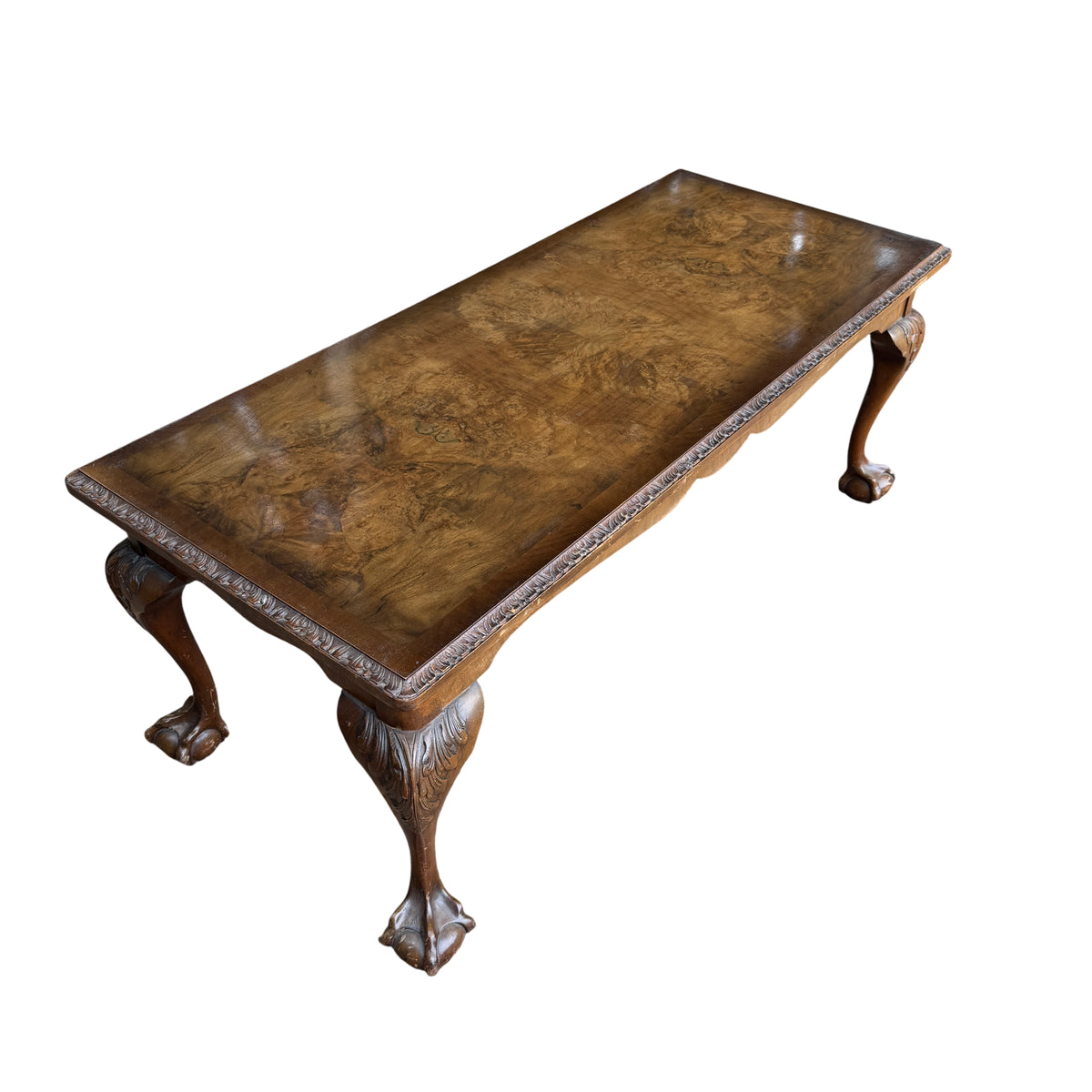 Low vintage walnut veneer coffee table with carved apron and ball and claw feet