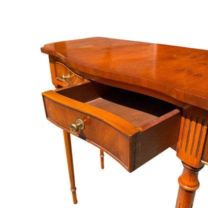 Front view of vintage hall table showing paired drawers and brass knobs