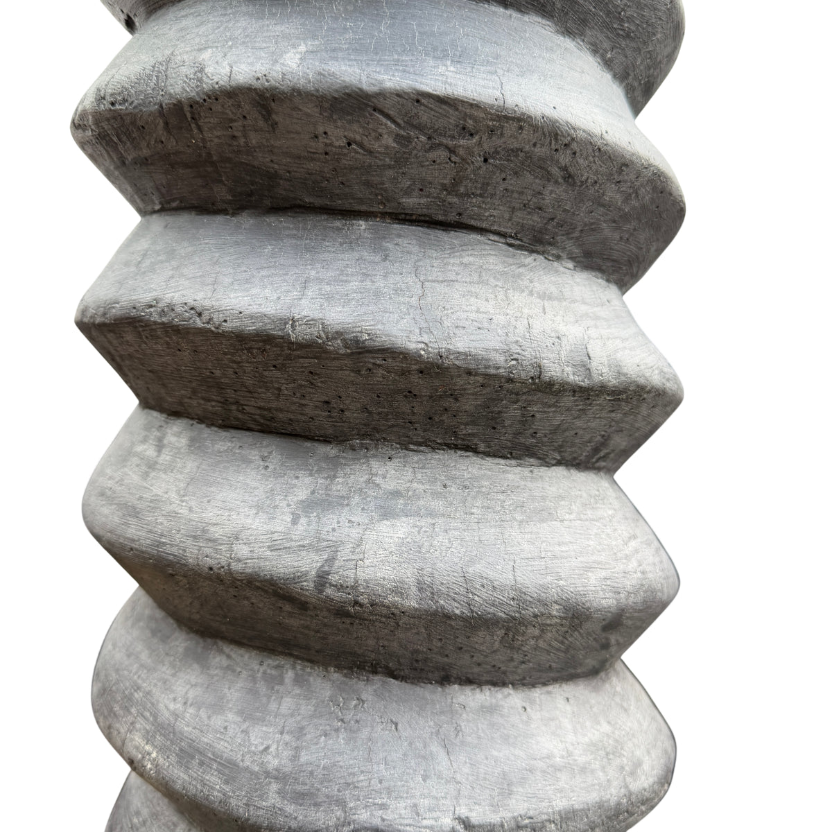 Lower section of wooden pedestal showing spiral carving and base detail