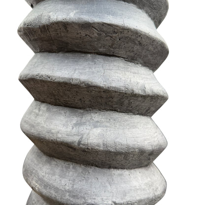 Lower section of wooden pedestal showing spiral carving and base detail